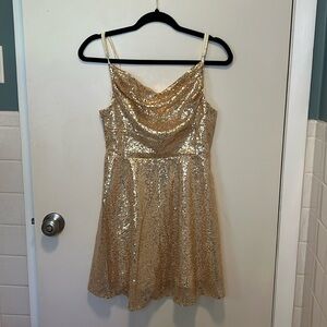 Gold sparkly sequin backless mini dress with spaghetti straps.